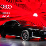 2026 Audi A6L luxury sedan in silver, showcasing sleek design with LED Matrix headlights, extended wheelbase, and premium 20-inch alloy wheels on a modern city street.