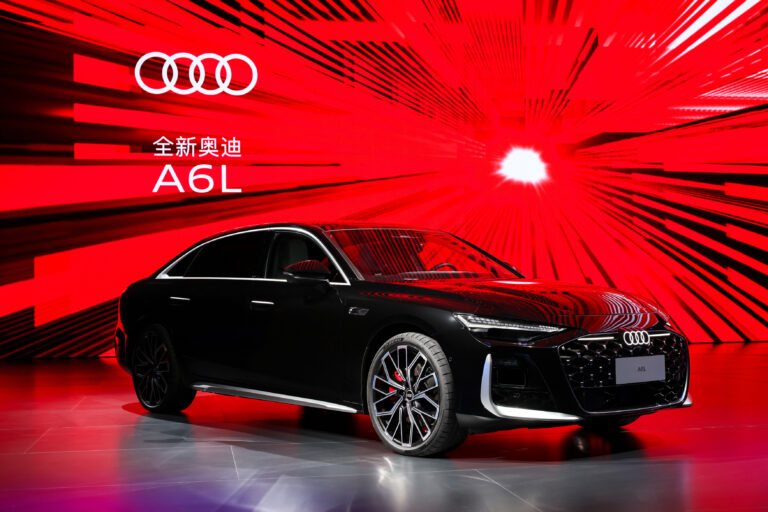 2026 Audi A6L luxury sedan in silver, showcasing sleek design with LED Matrix headlights, extended wheelbase, and premium 20-inch alloy wheels on a modern city street.