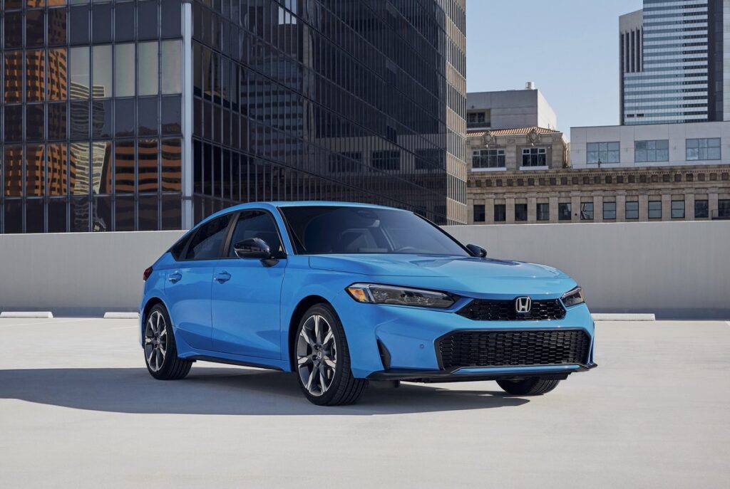 2026 Honda Civic Hybrid sedan in front three-quarter view with sleek styling and LED headlights.