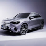 2027 Mercedes-Benz GLC parked on a scenic modern city street featuring sleek LED headlights, sporty front grille, premium alloy wheels, and elegant luxury SUV styling.