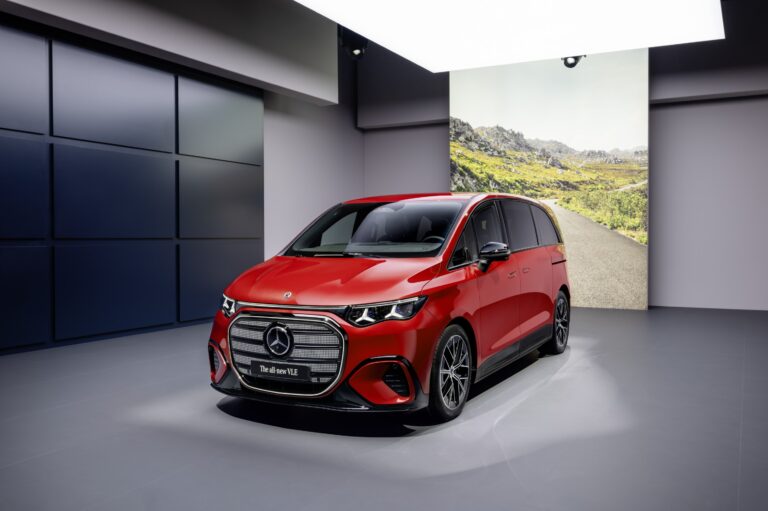 2027 Mercedes-Benz VLE luxury electric van parked in a modern urban setting with futuristic LED lighting, sleek aerodynamic design, large alloy wheels, and premium executive styling.