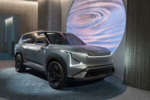 2027 Kia EV5 compact electric SUV with modern futuristic design and LED lighting in a studio setting