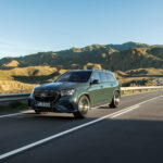 2027 Mercedes-Benz GLS parked in front of a modern luxury hotel featuring sleek LED headlights, large premium alloy wheels, elegant full-size SUV styling, and a bold chrome front grille.